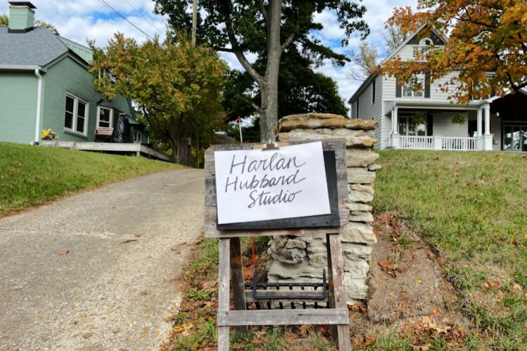 A sign on an easel in front of the hand-built Hubbard House Studio welcomes printmaking guests.