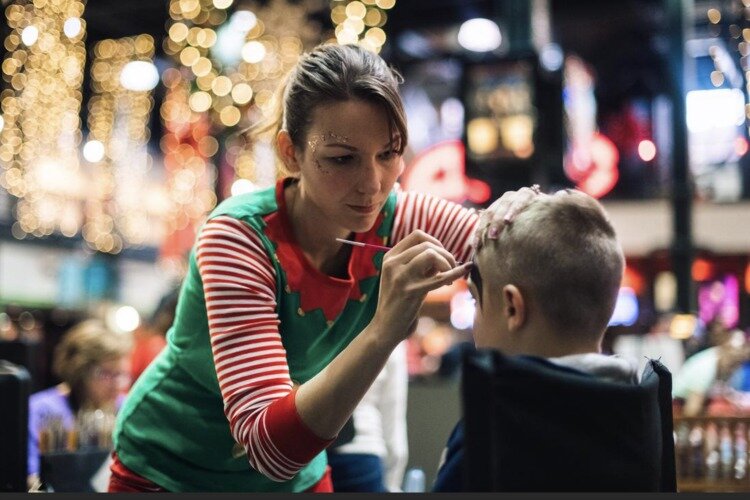 Kids can get their faces painted by an elf.