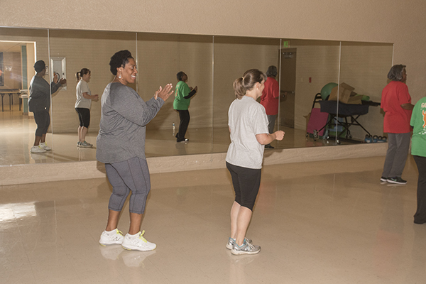 Bush Recreation Center's Vanessa Henderson (left) leads a dance-fitness class. 