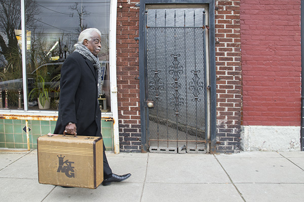 Philip Paul with one of Xavier's "traveling suitcases" of educational materials about King Records