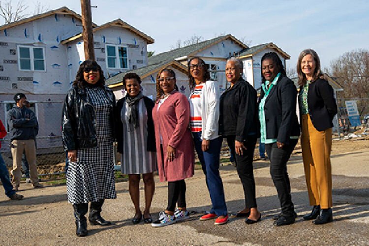 Stephanie Summerow, Joyce Powdrill, Tonya Key, Jeannie Stinson, LaVerne Mitchell, Ruby Kinsey-Mumphrey, and Denise Driehaus happily pose in front of new construction, knowing the benefits it will bring to the community. 