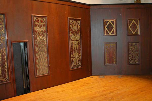 Eighteen carved panels from the original Hook & Hastings organ were hung in the orchestra pit.