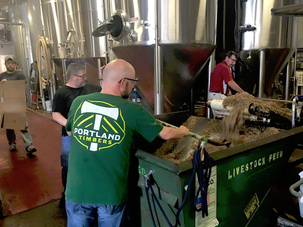 The BREW 100 class working with MadTree brewers to remove the spent grain from Window Sill.