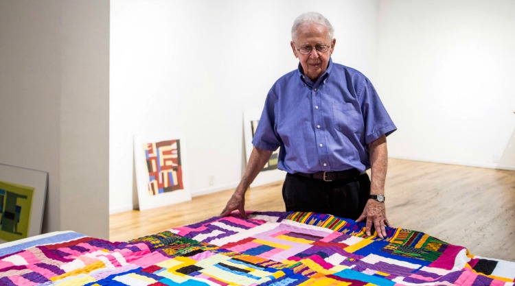 Carl Solway admiring the quilt of Mary Lee Bendolph, featured in the upcoming show.