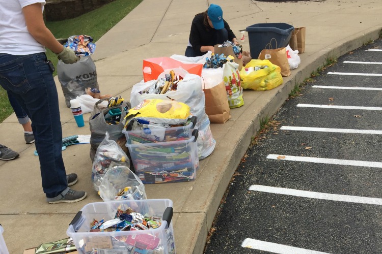 Pleasant Ridge families drop off their TerraCycling and Fay, with help, sorts it and sends it off.
