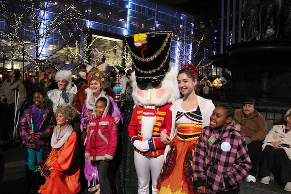 A group of holiday revelers poses at last year's Macy's Downtown Dazzle.
