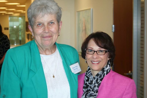 Sr. Sally Sherman (left) receives a 2014 grant from Kathy DeLaura of The Women's Fund 