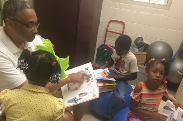 Clyde Gray reads to kids during the Summer Academic Enrichment program
