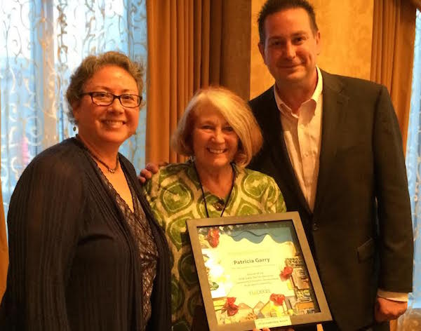 Patricia Garry (center) receives the 2016 national award for community development leadership from NACEDA Chair Sharon Legenza and Ohio CDC Association Executive Director Nate Coffman.