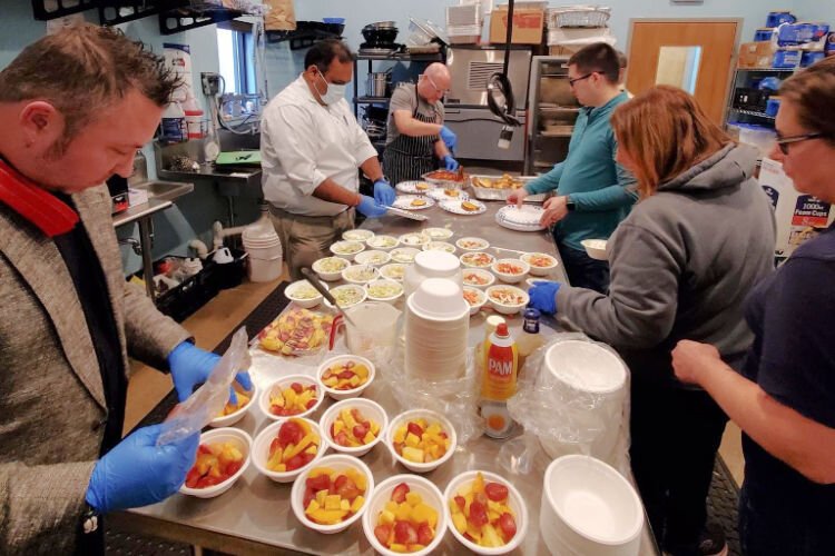 Volunteers and staff prepare meals for ESNKY guests.