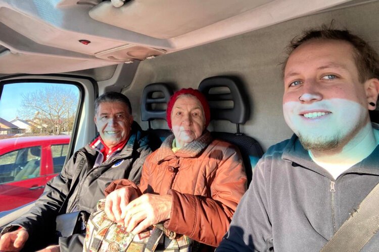 Devin Grome, right, transports a woman and her brother-in-law from Kyiv. She decided to leave the country after spending 12 days in a bomb shelter and six days without food and electricity.