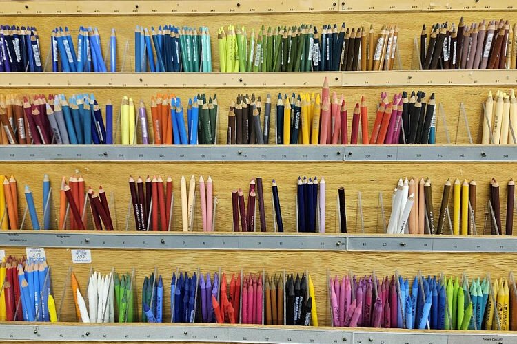 Colorful art supplies and materials line the walls.