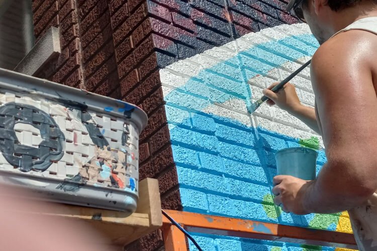 Dallas labored on the mural for five weeks, and noted that this was the roughest brick surface he’d ever encountered.