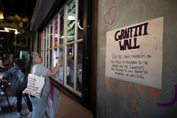 A graffiti wall is one of the many tools used by ArtWorks Civic Art Studio artists as a tool for listening to the public.