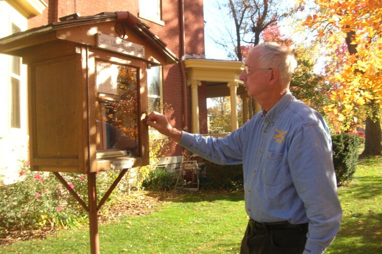 Bill Dean tends to his Westwood Little Free Library, charter #19336.