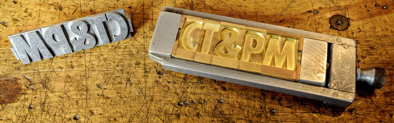 Cincinnati Type & Print Museum has a caste metal lettering machine that folds type with an indentation in brass, then metal. 