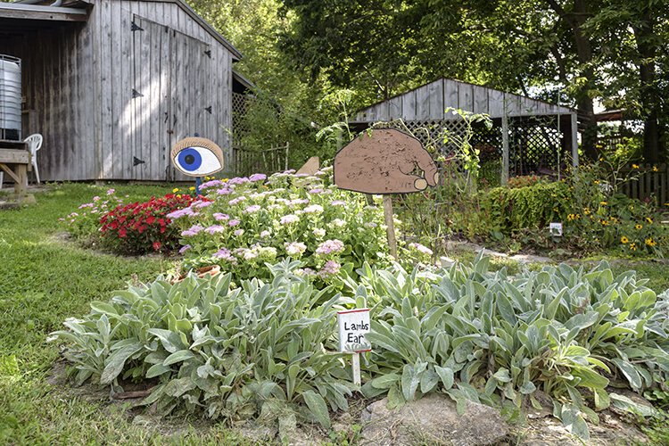 Garden art in the children's garden which is currently "a riot of blooms and buzzing pollinators."