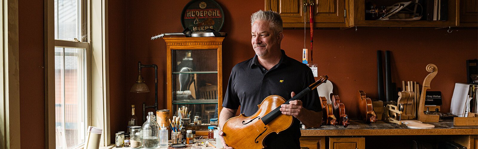Damon Gray still builds violins, violas, and cellos out of the small, homey workshop and studio behind his house in Prospect Hill.