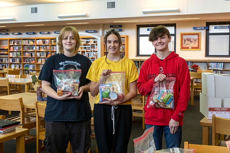 Conner High School students L to R: Jean Adkins, Mason Heitman and Declan Sefton with "survival kits".