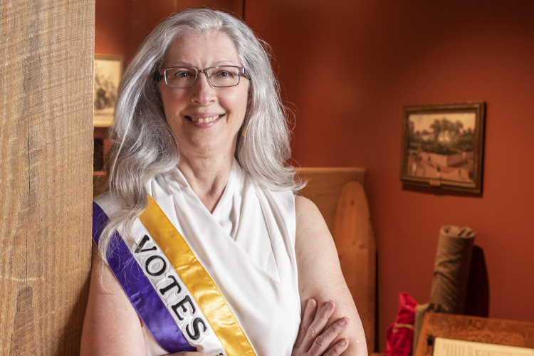 Durack wears her "Votes for Women" sash at the Cincinnati Museum Center.