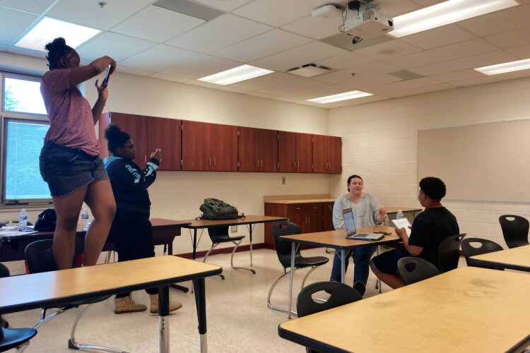 Lorraine and Tamia learning how to get the right perspective for interview photo shoot.