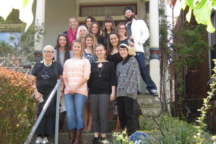 Voelker-Ferrier in front of her Northside home with students.