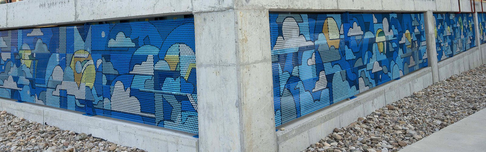 Grates that bend around the west and south sides of the building include an extensive Christian Dallas mural.