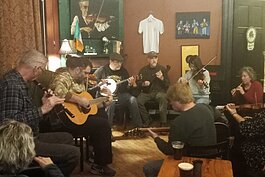 Every Thursday, the Center opens its doors for Pub Night, with live music and ample Guinness on tap. On this particular evening, a traditional Irish session, a fluctuating group of 8 to 14 string and woodwind players, performs traditional music.