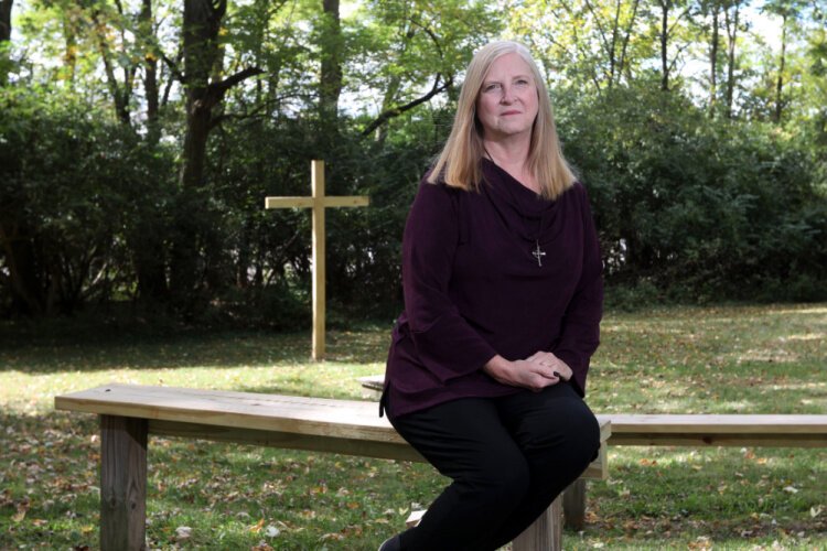 Reverend Deborah Bowsher in front of the Trinity United Presbyterian Church in Zanesville.