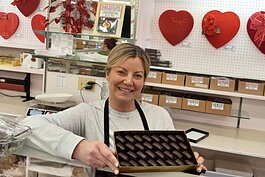 Kelly Schneider Morgan, a 3rd generation owner of Bellevue's Schneider's Sweet Shop, holds up a tray of the shop’s best-selling opera creams. Schneider’s has operated since 1939 and still uses some of the original equipment to make chocolate.