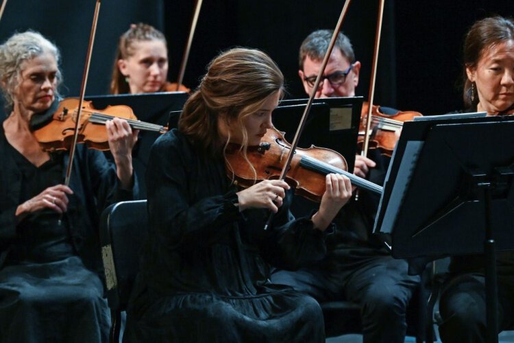 A close-up of Chamber Orchestra string performers during Summermusik. Manami White, a principal second violinist in the orchestra, enjoys the eclectic compositions the ensemble performs for the program.