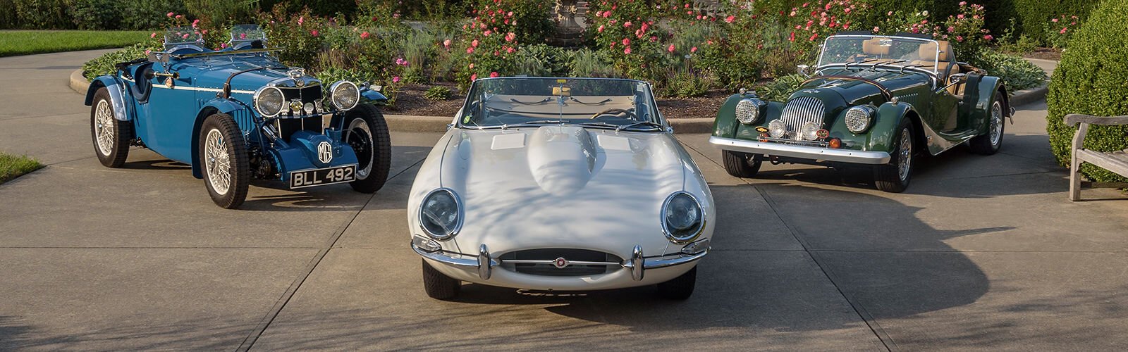 (left to right) A trio including a 1930s-vintage MG, a 1961 Jaguar XK-E Series 1, and a 1985 Morgan Plus 8 was photographed to promote this year’s Concours d’Elegance theme, Icons of British Motoring. 