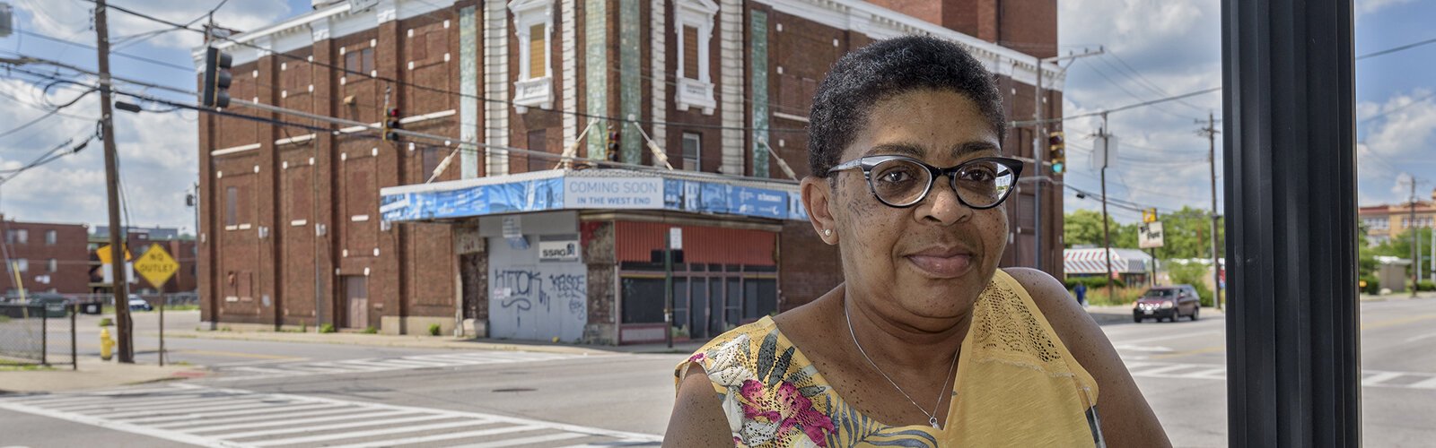 Lisa Wallers stands outside of a soon to be redeveloped building in the West End.