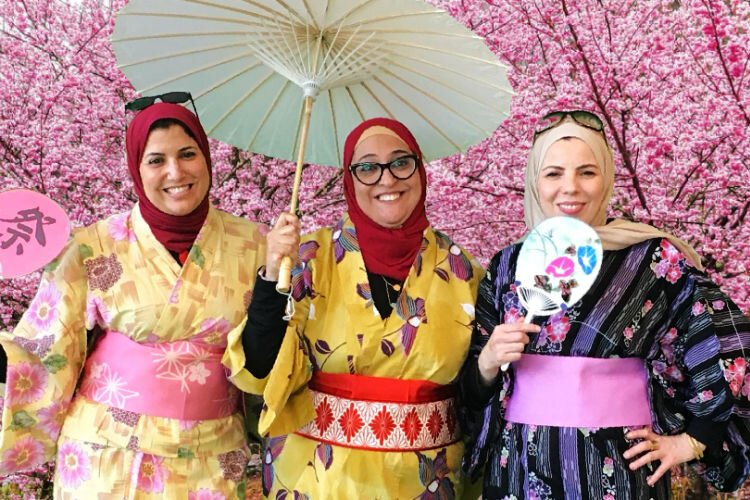 Asma Shita, Marwa EL'Kahky, and Amal Yaseen wear kimonos at the popular Japan booth at Boone County International Festival. 