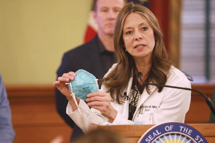 Dr. Acton discusses the importance of masks at a press conference.