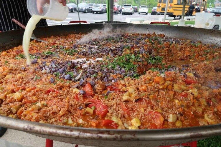 The paella, or "stone soup," will be made with whatever surplus produce they receive that week.