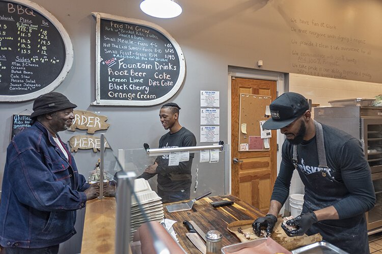 Just Q'in owner Matt Cuff prepares barbeque at his Walnut Hills location.