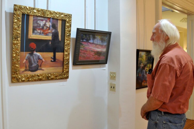 Steve Kosztala admires Buck’s painting