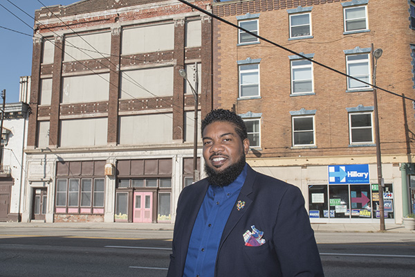 Allen Woods of MORTAR in front of the org's future home on Gilbert Ave.