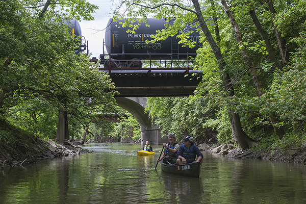 Casey Coston (front) sees Mill Creek up close with Greg Bechtel and a kayaking Jenifer Eismeier