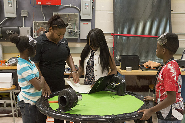 Andrea Martinez helps her students during the summer science program at Cincinnati State 