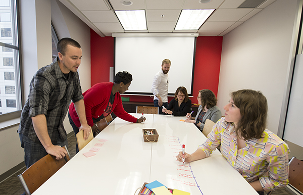 Ramsey Ford (center) leads a Design Impact team discussion