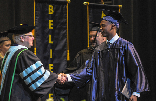 Jabril Bryant shakes the hand of Sister Jeanne Bessette, DPCR president