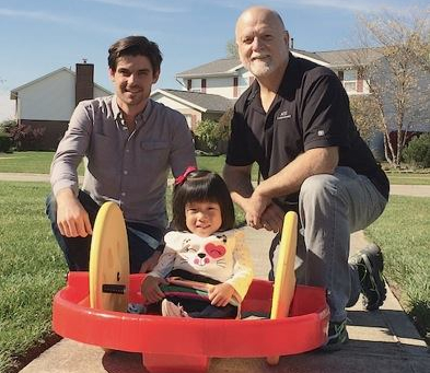 Chris Kubik (left) and volunteer builder Charlie Garner show Lilyan her new scooter