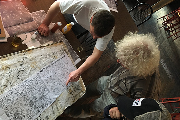 "Commodore" Bruce Koehler (center) brings watershed maps to share over drinks at Pike Bar & Grill 