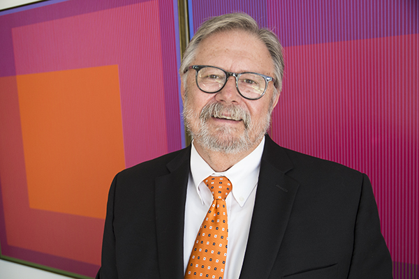 Art Academy President John Sullivan in his office, featuring work by Op-Art pioneer Julian Stanczak