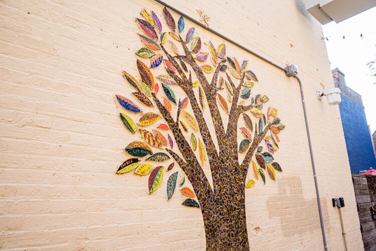 The leaves on this Imagination Alley mosaic hold the names of its creators.