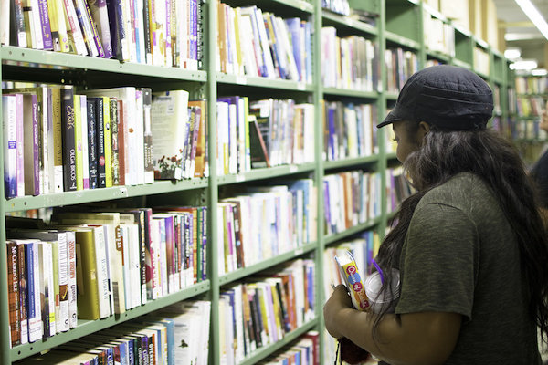 A patron explores titles at the Friends Warehouse.