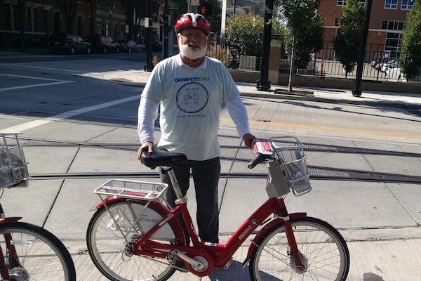 Queen City Bike's Frank Henson poses with a Cincy Red Bike.