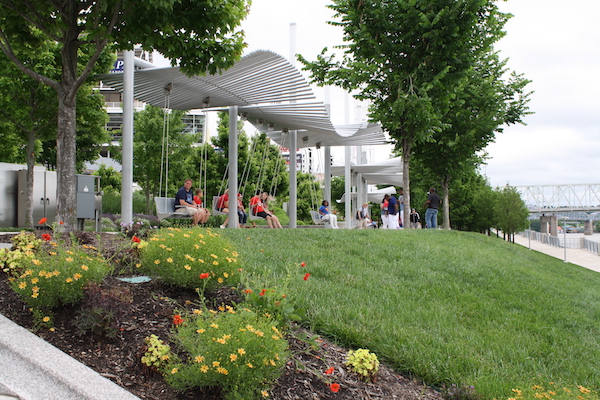 Reds fans enjoy the giant swings along the riverfront before a game.